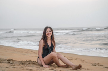 Fototapeta na wymiar a girl on a beach near the sea