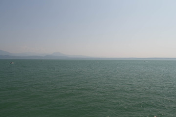 Lake Garda with mountains on background, Lombardy, Italy.