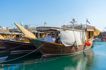 Fototapeta na wymiar Traditional boats called Dhows are anchored in the port near Museum of Islamic Art Park,Doha, Qatar.