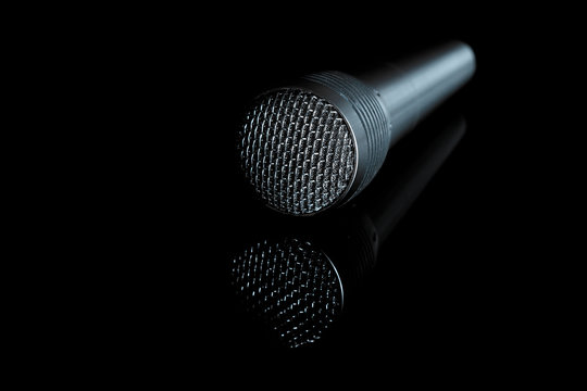 Audio microphone close-up on a black background, copy space