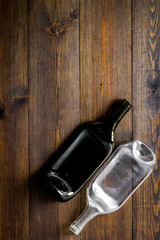 Empty bottle on wooden background top view copy space