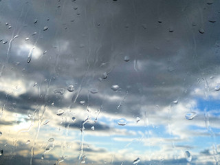Raindrops on the glass against the blue sky.