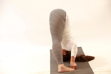 woman practices yoga or pilatis
