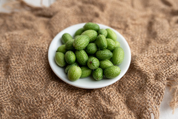 Freshly harvested cucamelons, Mexican sour gherkin pepquino or mouse melon. Sour grape size cucumbers. 
