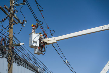 maintenance of electricians work with high voltage electricity on the hydraulic bucket