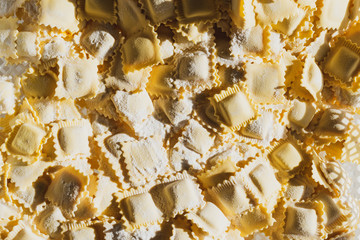 production process of ravioli, tortellini and cappelletti, typical Italian fresh pasta - basket full of fresh pasta