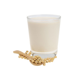 A glass of soy milk And soy beans in a wooden spoon isolated on white background.