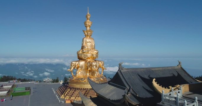 Aerial view of golden buddha statue and Chinese Traditional Architecture at Jinding Emei mountain summit the UNESCO World Heritage site 4k drone footage