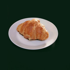 Croissant in white plate isolated black background