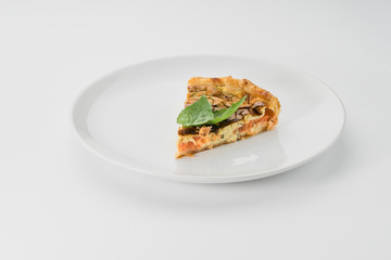 pie with fish and greens on a white background