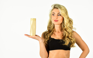 Sun Kissed. Body lotion. Self tanning Products. Girl with smooth skin hold cosmetics bottle. Self...