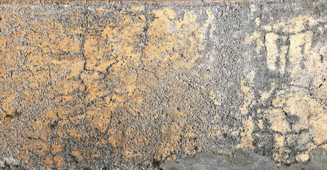 Old stucco wall texture of gray, white and yellow color
