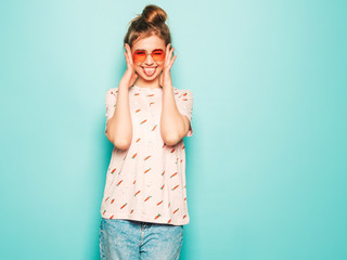 Young beautiful woman looking at camera. Trendy girl in casual summer T-shirt clothes showing her...