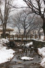 Winter in Korea, traditional village and wooden bridge.