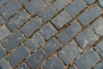 Background image of texture of a pedestrian road paved with paving stones