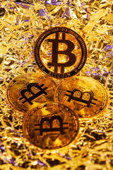 4 gold Bitcoin with golden reflect background. Great close-up shot.