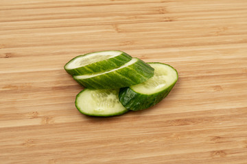 Green cucumber on a wooden background