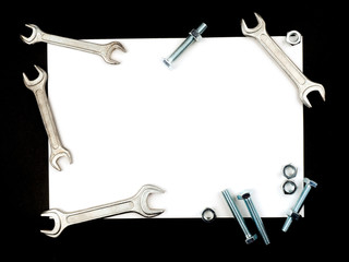 Text insertion frame lined with bolts, nuts and wrenches