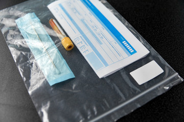 medicine, healthcare and pandemic concept - beaker with test, cotton swab and medical report in plastic zipper bag