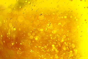 Lot of small bubbles on an yellow background, macro shot of liquid soap, macro shot of glass with...