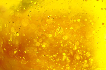 Lot of small bubbles on an yellow background, macro shot of liquid soap, macro shot of glass with beer, macro shot of cocktail with fruit juice