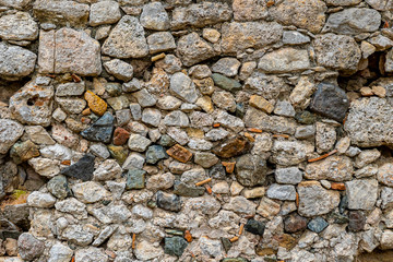 stone walls of an ancient temple in the summer in the forest