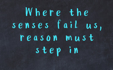 Chalk inscription of smart quote on black desk © iushakovsky