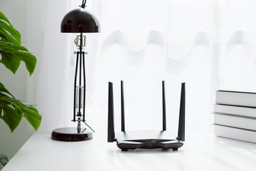 Wifi and broadband router on white table in room at the home. - obrazy, fototapety, plakaty
