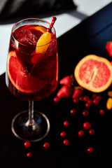 Glass of aperol spritz cocktail on wooden table in cafe