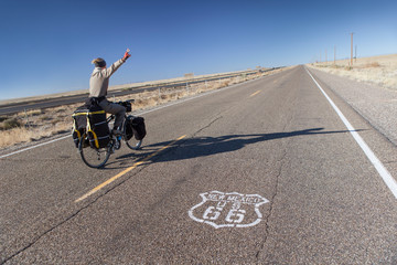 Man Riding Bicycle on Historic Route 66 in New Mexico, USA.