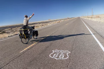 Gordijnen Man Riding Bicycle on Historic Route 66 in New Mexico, USA. © Anton Sokolov