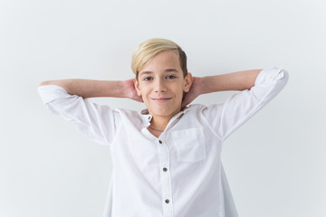 Solitude, loneliness and boredom concept - Bored teen student sitting in a school chair isolated on white background
