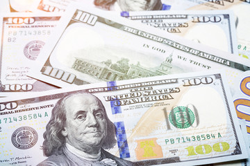 Obraz na płótnie Canvas American hundred dollar bills. Money background, angle view.