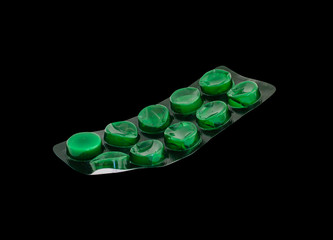 Used tablets in green  blister pack  isolated on black copy space