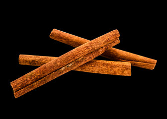 Group fragrant cinnamon sticks isolated on black background