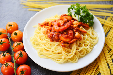 Spaghetti bolognese italian pasta with shrimp prawn served on white plate with tomato parsley in the restaurant italian food and menu
