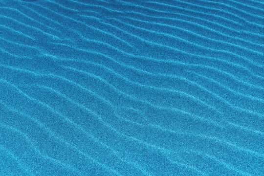 blue sand dunes closeup, sun flare, abstract