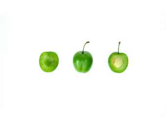 Unripe plum on white background
