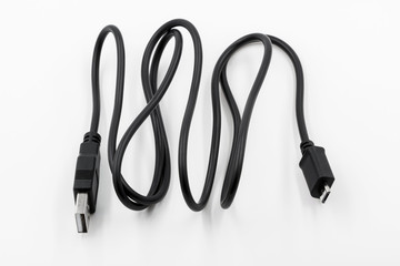 Black adapter USB to micro USB type c data and power cable on white background. Closeup