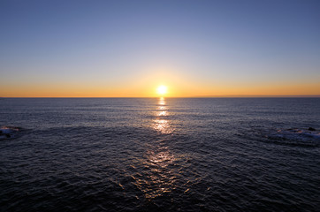 Sun rising in the dark dawn sea. Yeongdeok, Korea