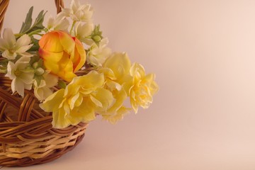 Beautiful Easter photo of a basket with flowers, and decorated with colored eggs