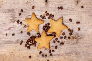 Shortbread in the form of stars on a wooden background.