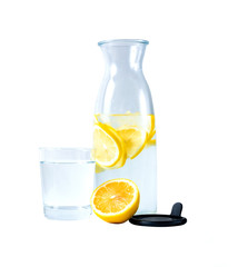 transparent carafe with water
 and lemon. A glass of water. Isolate