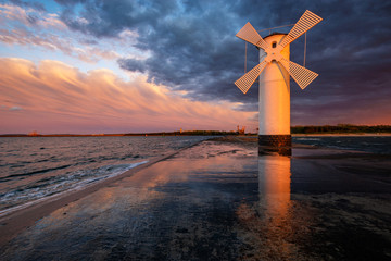 lighthouse in the shape of a windmill in Swinoujscie in Poland during the dramatic sunset