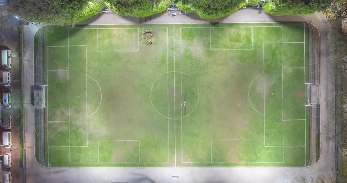Aerial hyperlapse of bird's eye view of people playing football