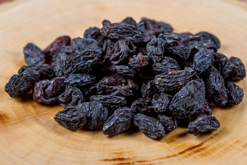 Uzbek blue raisins closeup on a wooden table. Baking ingredients. Healthly food.