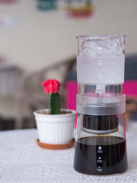 Cold brew coffee maker on the table. cold drip uses a simple steeping technique that helps highlight the natural chocolate, floral, and fruity notes inherent in coffee.