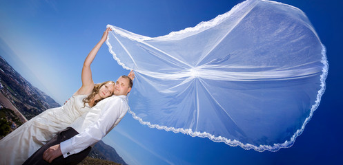 beautiful wedding couple in nature on blue sky