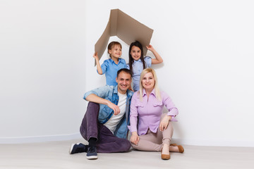 concept housing a young family. Mother father and child in new house with a roof