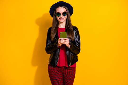 Portrait of her she nice-looking attractive lovely pretty cheerful cheery straight-haired girl using app web service isolated on bright vivid shine vibrant yellow color background